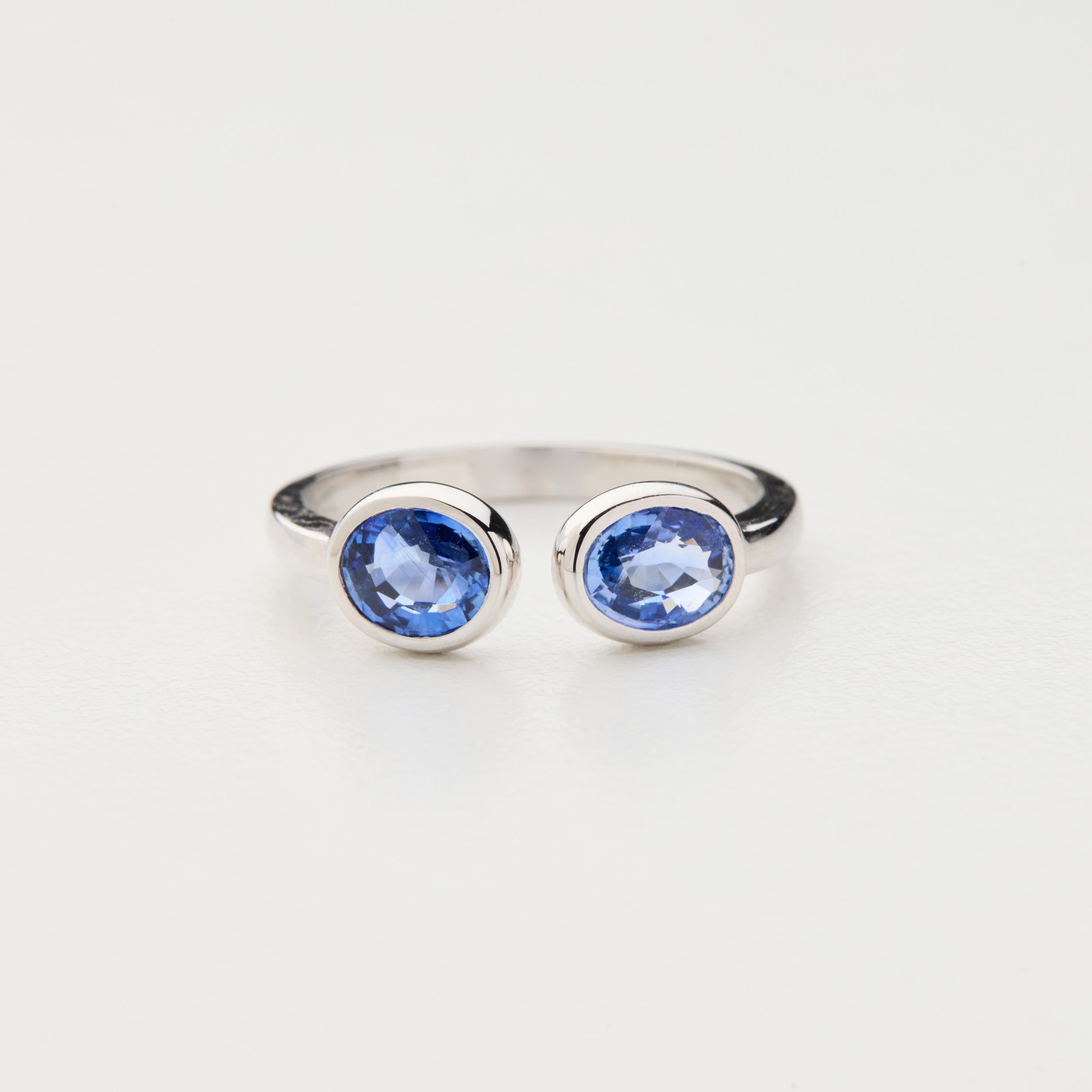 Infinity Duo ring with two cornflower blue sapphires in 18K white gold