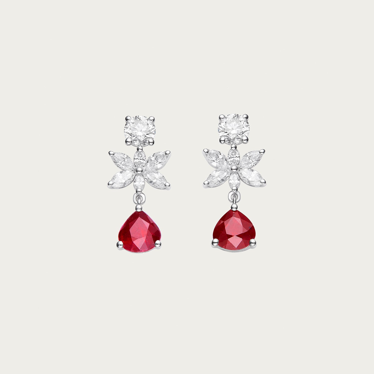 Inner Bloom earrings with unheated Mozambique ruby center stones in 18K white gold