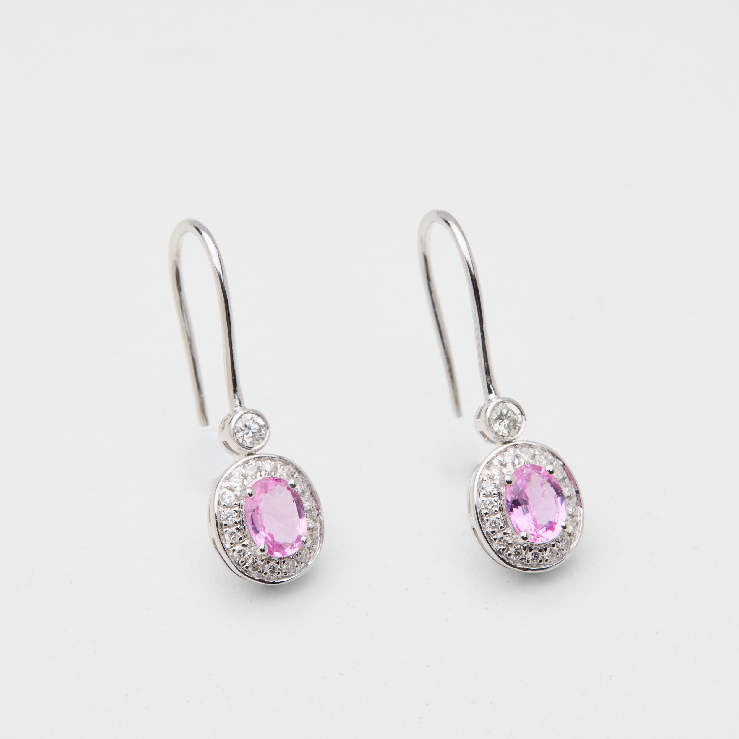 Close-up of Padparadscha pink sapphire drop earring in Aura Field collection