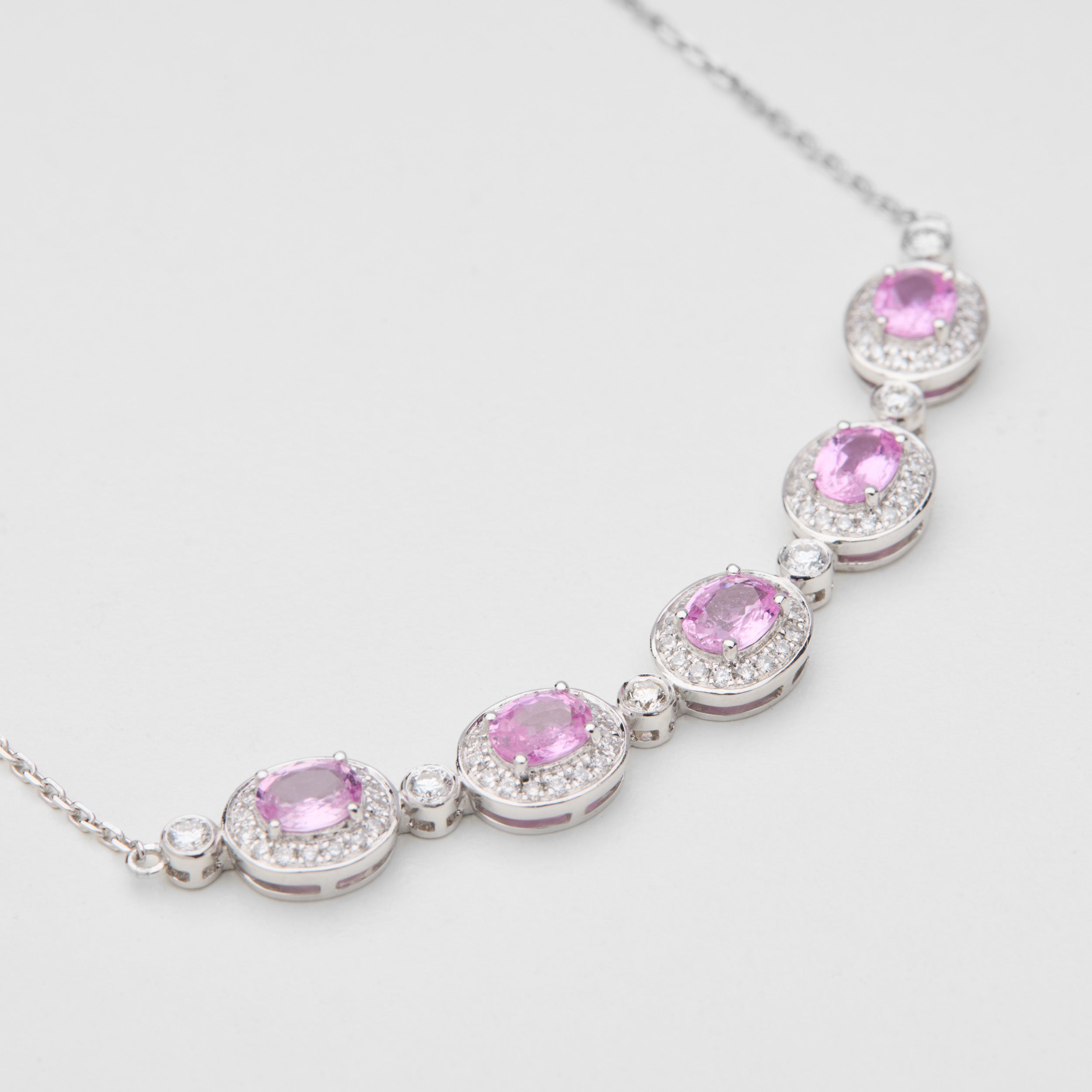 Detail of Padparadscha pink sapphire stations in Aura Field necklace